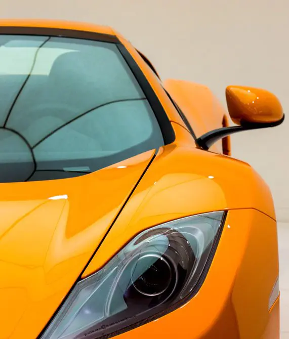 Mullinax Body Shop | close-up of a yellow sports car against a beige background